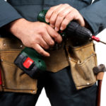handyman with drill and toolbelt